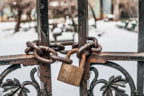 locked gate in Harlem on cold winter day, snow on ground