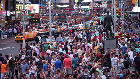 Times Square with crowd of people swarming street in summer