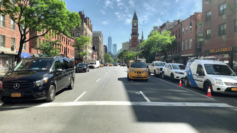 taxi approaching crosswalk stop Jefferson Market Library Freedom Tower background the Village Manhattan New York City NYC