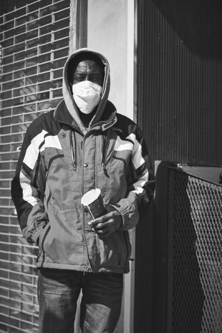 man in mask with cup in winter New York City
