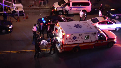 ambulance on street at night, injured person on stretcher being put into FDNY vehicle in 1080 HD in NYC