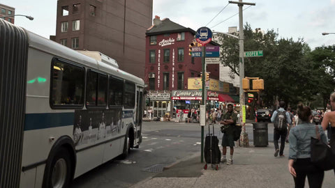 accordion bus departing at Cooper Square in East Village on summer day in Manhattan NYC