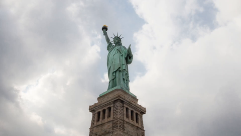 Statue of Liberty with base on bright sunny day - 4K full body upward angle timelapse in New York City