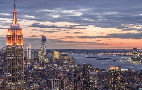 Empire State Building and Freedom Tower at sunset - famous skyscrapers in Manhattan at night with East River in distance in NYC