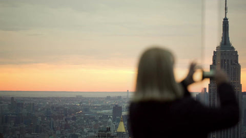 tourist woman taking picture of Empire State Building from high view at sunset in 1080 HD in NYC