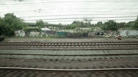 train tracks with graffiti on gritty walls