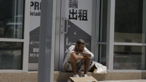homeless caucasian man in shorts in the summer counting change on street in 4K New York City