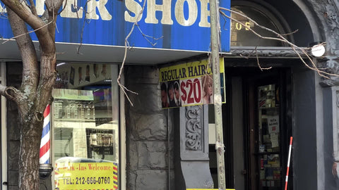 barber shop sign with classic spinning pole on Upper West Side Manhattan New York City NYC