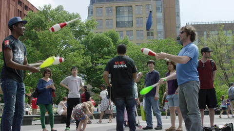 jugglers in Washington Square Park on summer day - juggling pins in NYC