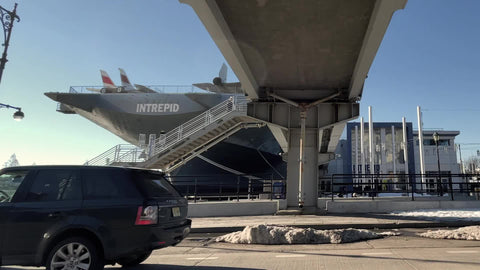 Intrepid ship Pier 86 at 46th Street Maritime Museum on Hudson River cars passing on West Side Highway Manhattan New York City NYC