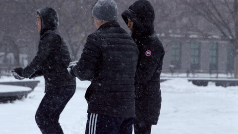 College student throwing snowball in Washington Square Park NYC