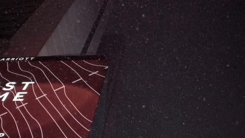 upward angle on Times Square building at night with snow falling down in slow motion - snowing in winter