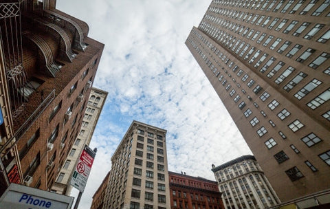 alternate side parking sign in Downtown Manhattan - upward angle of towering buildings