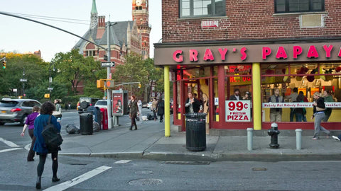 famous Gray's Papaya on 8th Street in Greenwich Village with Jefferson Market block tower on 6th Ave