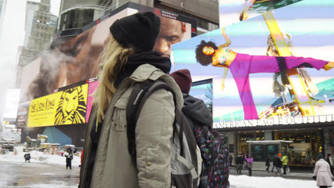 gorgeous blonde tourists looking around Times Square in awe in the snow - snowing in Manhattan morning in NYC