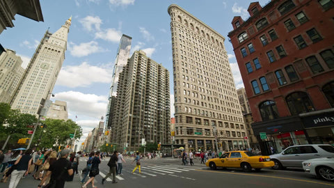Flatiron Building in Manhattan on summer day - 23rd street - people walking