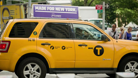 caravan taxi cab stopped at traffic light on Manhattan summer day