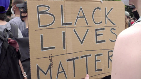 Black Lives Matter sign held by white ally at BLM rally protest in New York City