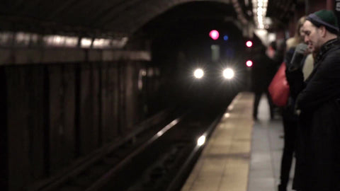 nervous man biting fingernails waiting for subway - train entering station platform in slow motion