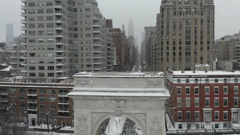 aerial toward birds on Washington Square Park arch white winter snow - blizzard snowing in NYC