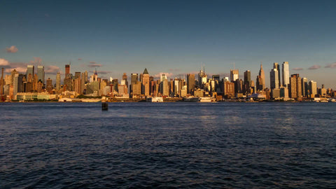 Midtown Manhattan skyline skyscrapers going from day to night in timelapse pushing in slowly with sunset in 1080 HD and 4K NYC