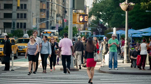 people crossing street at crosswalk on summer day on 5th Avenue in Manhattan