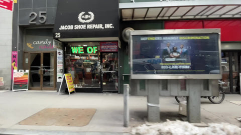 man riding bicycle on sidewalk in Financial District Downtown Manhattan New York City NYC