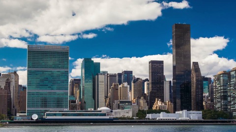 UN Building in skyline daytime with blue sky and clouds - 4K HDR timelapse of Manhattan