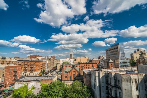 Harlem neighborhood with church from rooftop on bright beautiful sunny summer day in Uptown Manhattan, blue sky and clouds