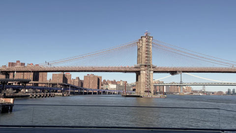 Brooklyn Bridge over East River and famous heart sculpture from peace love happiness exhibit at South Street Seaport Manhattan New York City NYC
