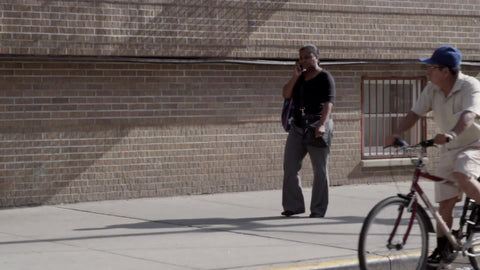 man on bicycle gawking at woman walking in street on summer day - gawker staring at lady - delivery man looking at girl