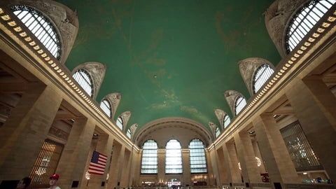 loud and crowded Grand Central Station Terminal interior - large room with people walking up and down stairs in summer in NYC