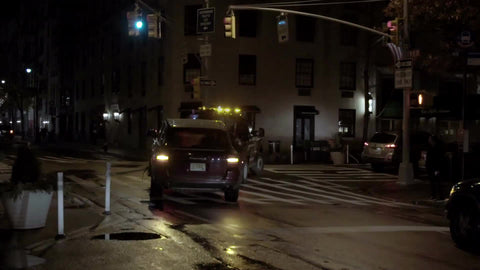 NYPD tow truck turning corner at night - towing car