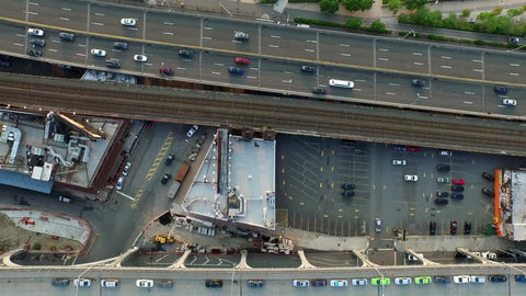 aerial of cars driving in traffic on West Side Highway by Hudson River over Manhattan NYC