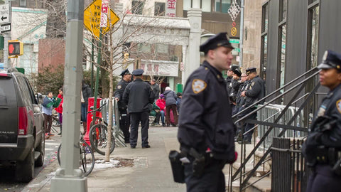 NYPD police officers chatting - white male cop and black female officer talking on street