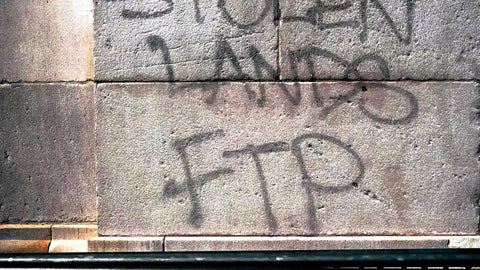 Stolen Lands FTP spray painted on arch in Washington Square Park
