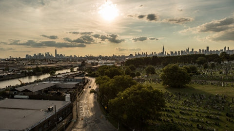 Manhattan skyline with Calvary Cemetery in Queens at sunset in early evening late afternoon in NYC