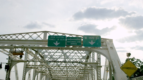 entering Macombs Dam Bridge and Adam Clayton Powell Jr BLVD sign from driving POV in the Bronx - 4K NYC