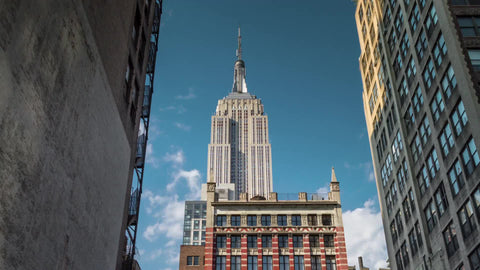 Empire State Building - timelapse during day - close-up view from alley between two buildings