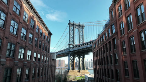 pulling back from Empire State Building view from Manhattan Bridge from Brooklyn between buildings New York City