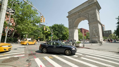 Washington Square Park North with arch monument on bright sunny day