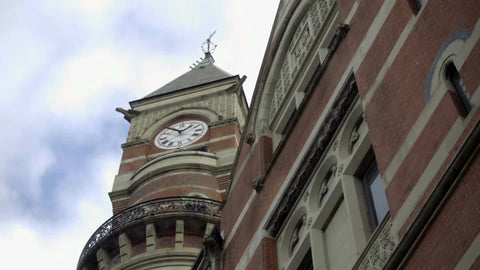 Jefferson Market Library clock tower, upward angle in Greenwich Village on beautiful day tilting down to street, Manhattan NYC