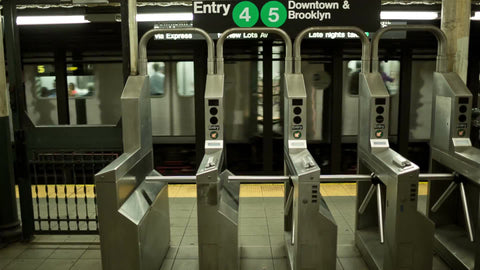 turnstiles at subway station for the 4 and 5 line - downtown and brooklyn sign in NYC