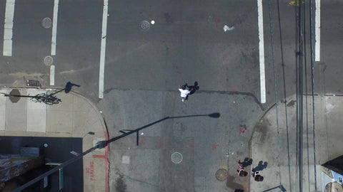 aerial of kid skating in Brooklyn streets