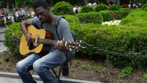 man playing guitar on summer day in Washington Square Park - 4K and 1080 HD in NYC