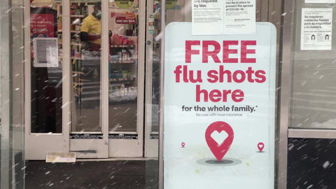 free flu shots sign outside CVS pharmacy drugstore in New York City NYC