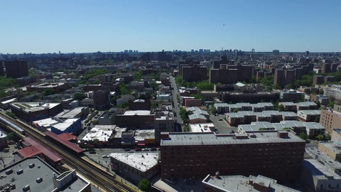 aerial over houses in the Bronx with public housing projects