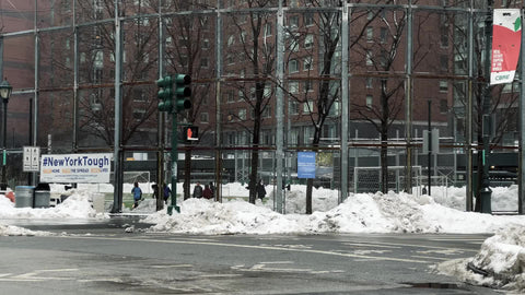 kids playing in schoolyard behind fence with New York tough sign in West Village Downtown Manhattan New York City NYC