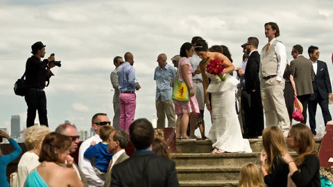 photographer taking photographs at wedding with Empire State Building view in background