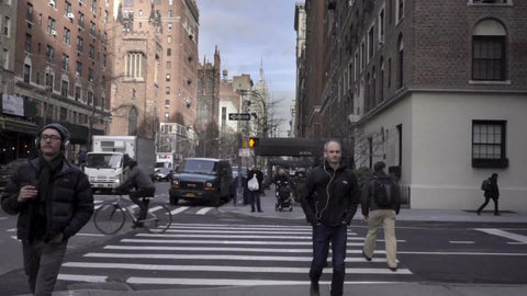 people walking down Lower 5th Ave in fall or winter cold day Empire State Building in distance at crosswalk in Manhattan slow motion